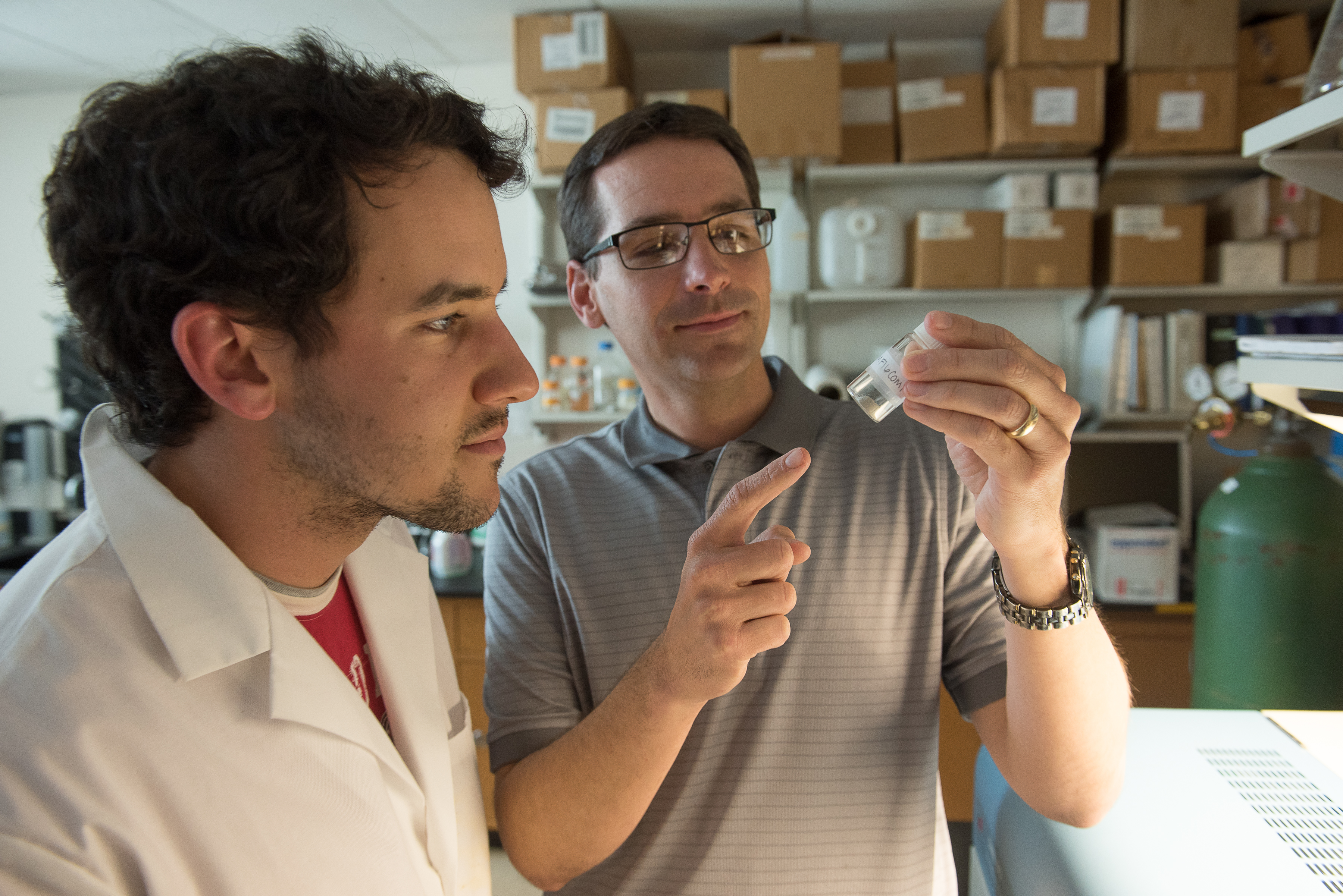 student looking at a beaker