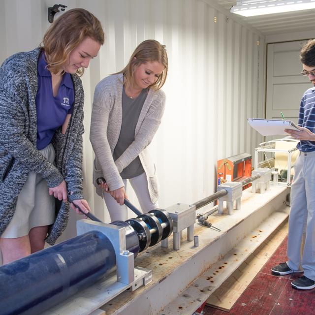 students working on machinery