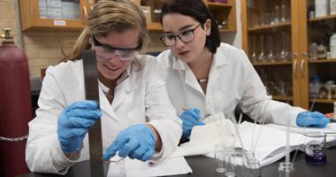 students working together measuring a beaker
