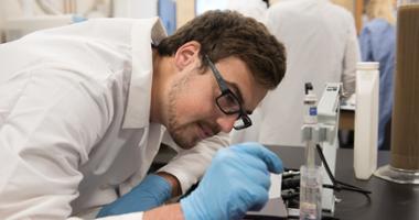 student looking at a beaker