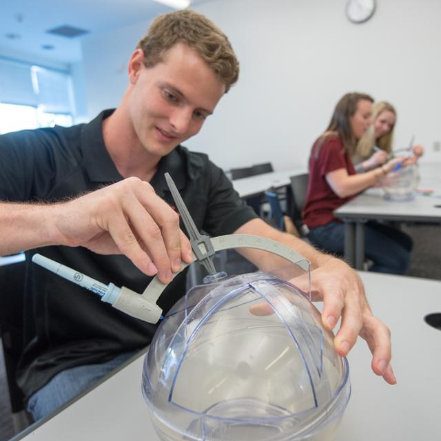 student working with math manipulative