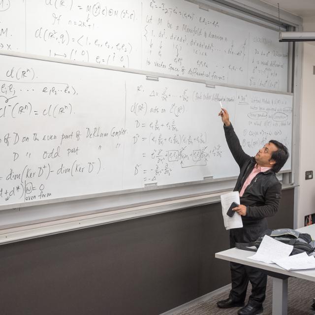 student working on a whiteboard