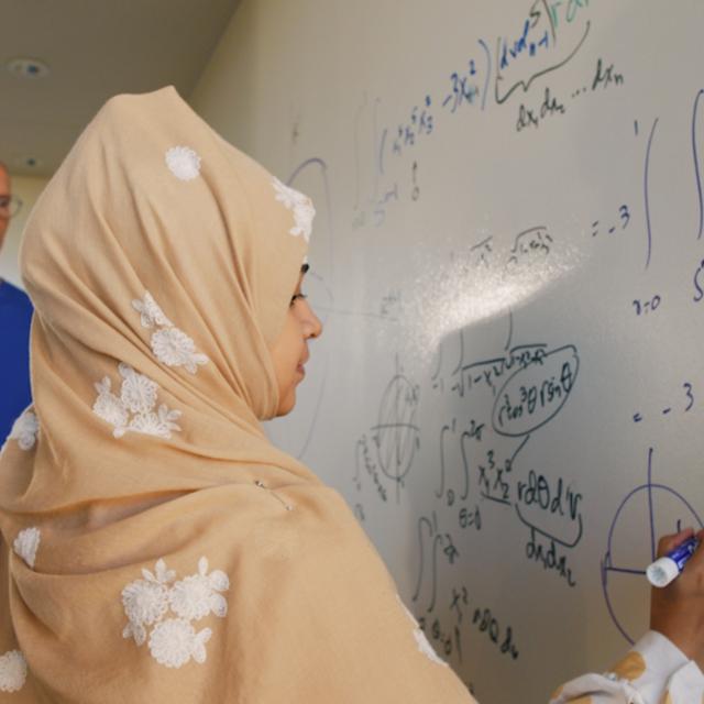 student working on a whiteboard